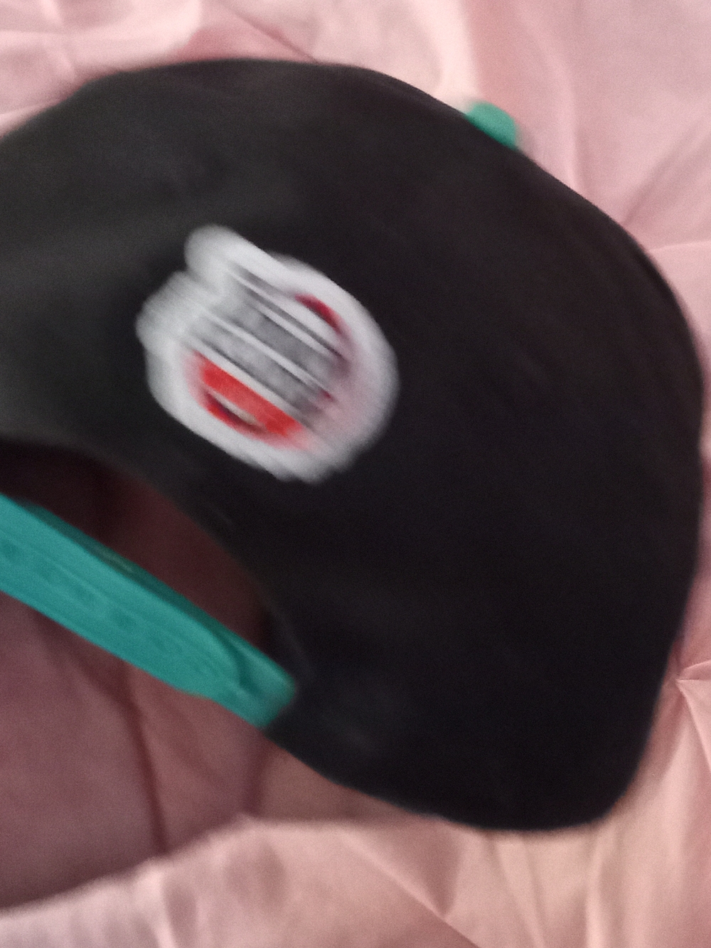 Black Snapback Hat with Teal Adjustable Strap and Round Patch